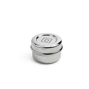 Small round stainless steel container with D - Dalcini logo on etched on top