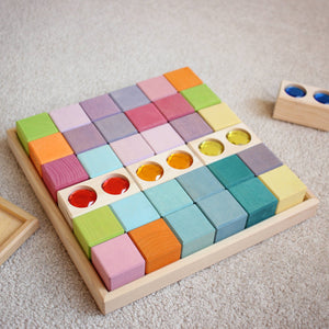 3 double gem blocks by Nurture Play Australia in red, orange, and yellow stacked into a Grimm's pastel block tray. 